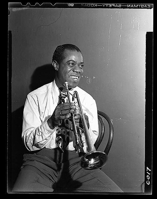 Louis Armstrong posing with trumpet