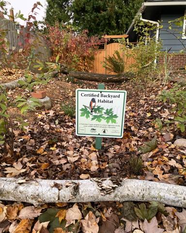 Sign in yard that indicates a certified backyard habitat