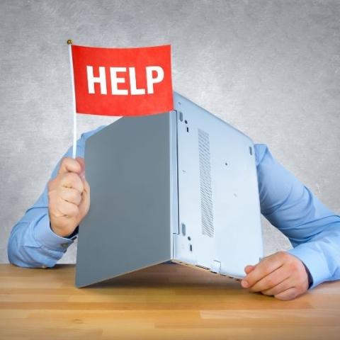 man with a computer and a help sign