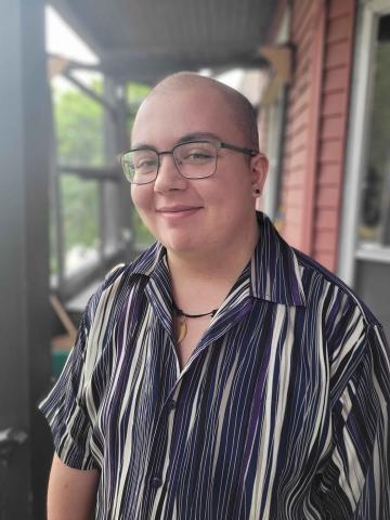 author photo of Silas Maxwell Switzer in a striped shirt