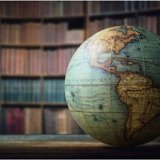 globe in front of bookshelves