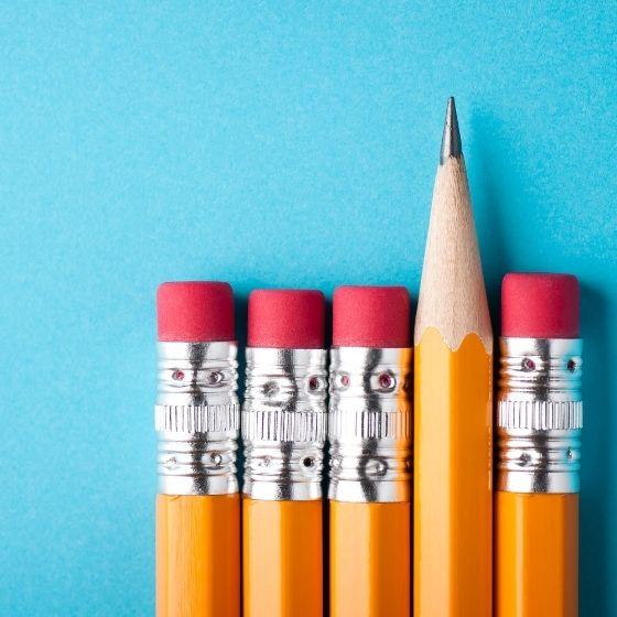 row of pencil tops with one sharpened pencil tip