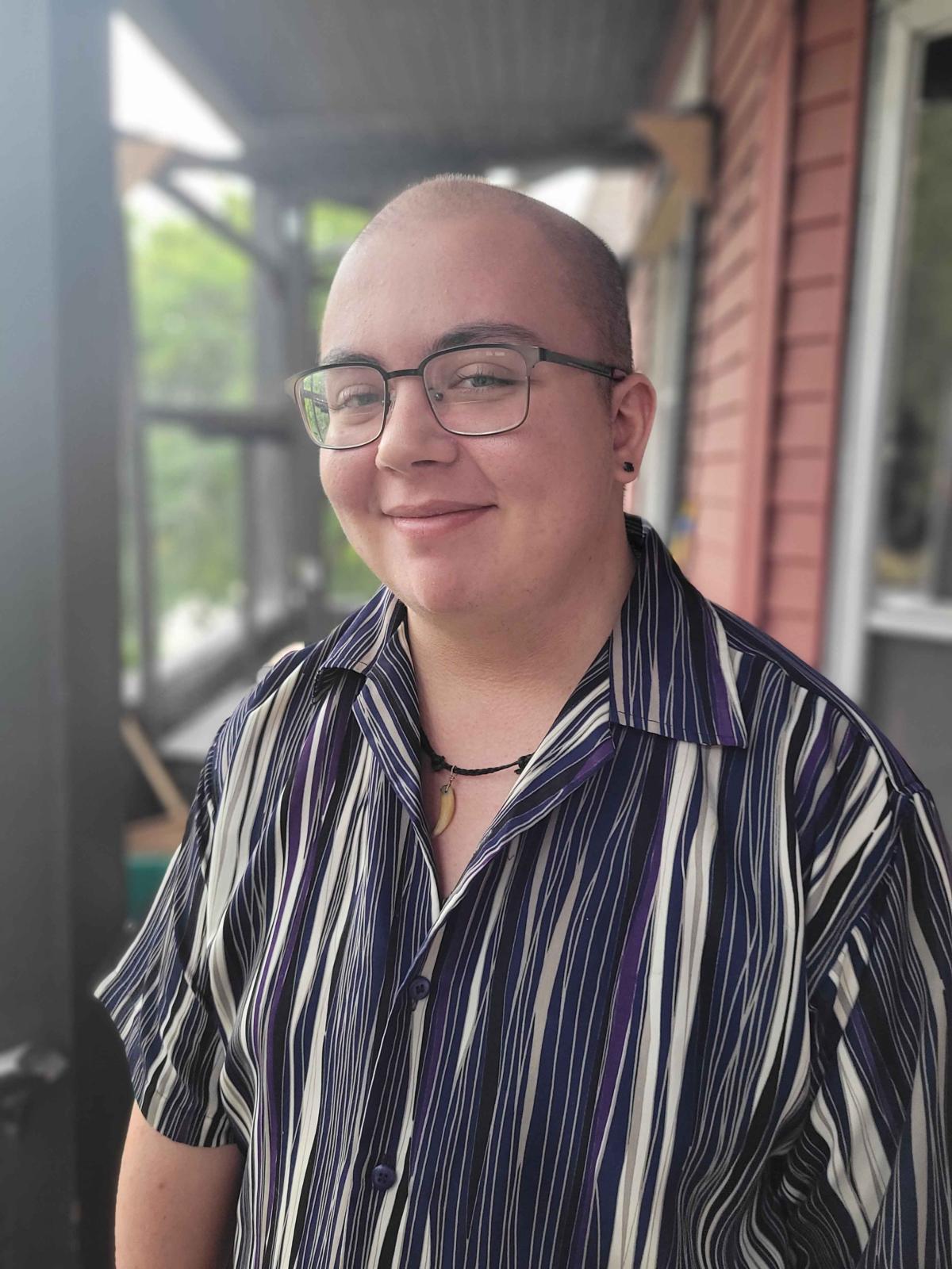 author photo of Silas Maxwell Switzer in a striped shirt
